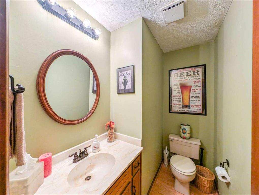 3838 Hunting Ridge Drive Southwest Lilburn, GA 30047 - Photo 25 of 56 a bathroom with a toilet sink and mirror