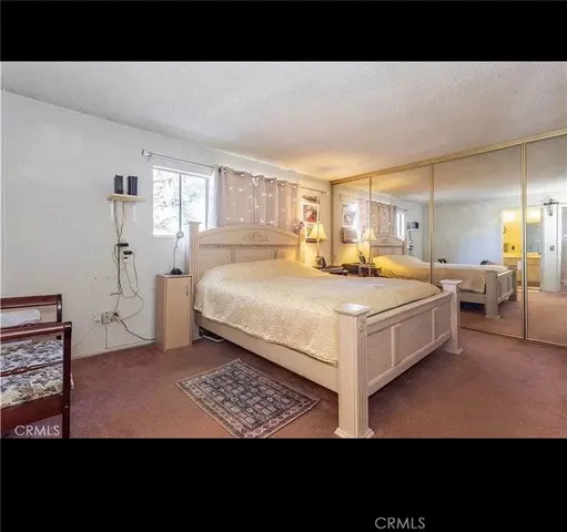 a living room with a bed furniture and a window