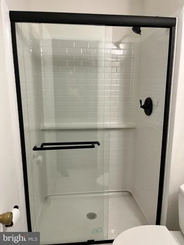 a white toilet sitting next to a bathroom sink