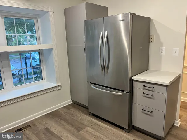 a kitchen with stainless steel appliances a refrigerator and a window