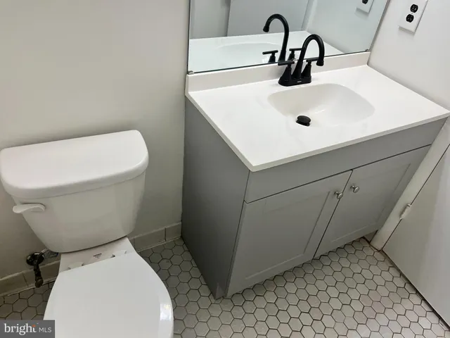 a white toilet sitting next to a bathroom sink