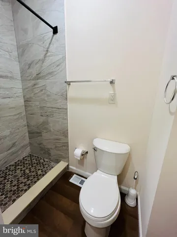 a white toilet sitting next to a bathroom sink