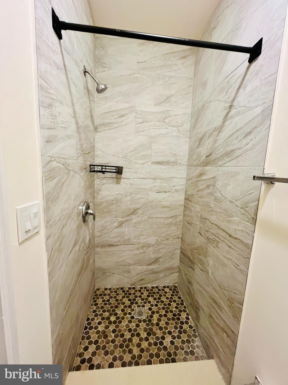 6249 Reedland Street, Unit 1M Philadelphia, PA 19142 - Photo 6 of 9 a bathroom with a shower