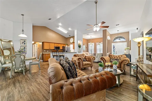 a living room with lots of furniture and a wooden floor