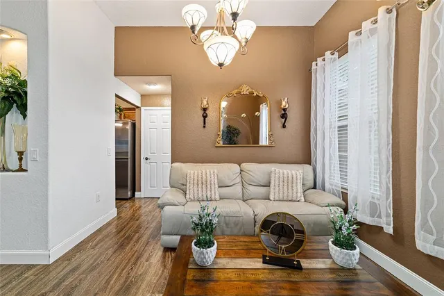 a living room with furniture and a mirror