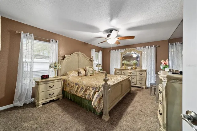 a spacious bedroom with a bed and a large window