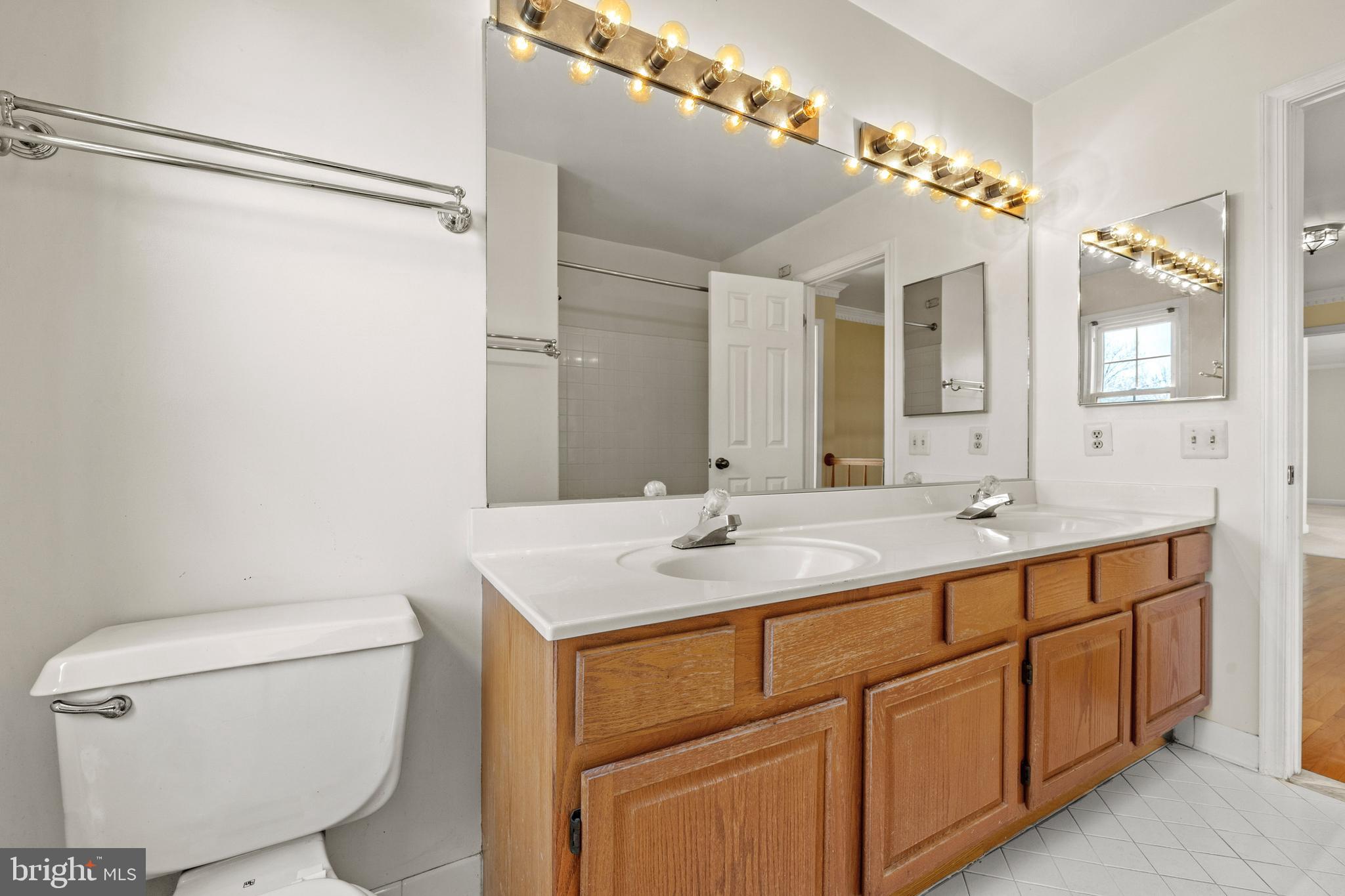 109 Englefield Drive Gaithersburg, MD 20878 - Photo 45 of 67 a bathroom with a toilet sink and mirror