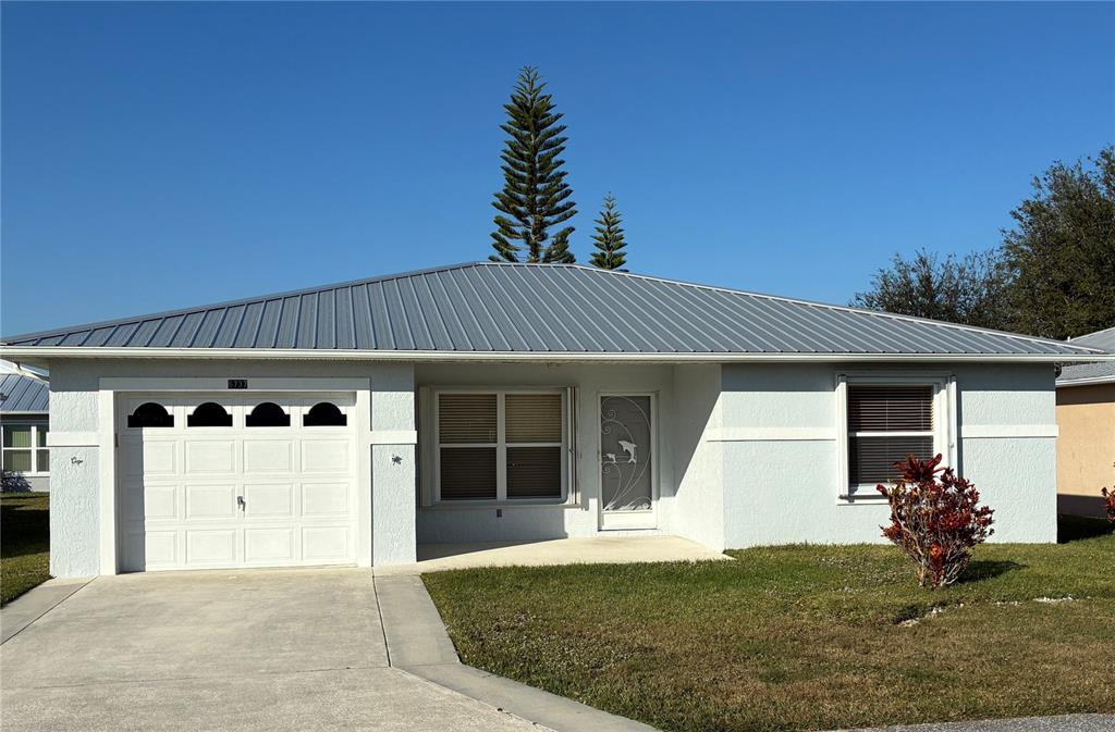 6737 Tulipan Fort Pierce, FL 34951 - Photo 1 of 1 a front view of a house with a yard