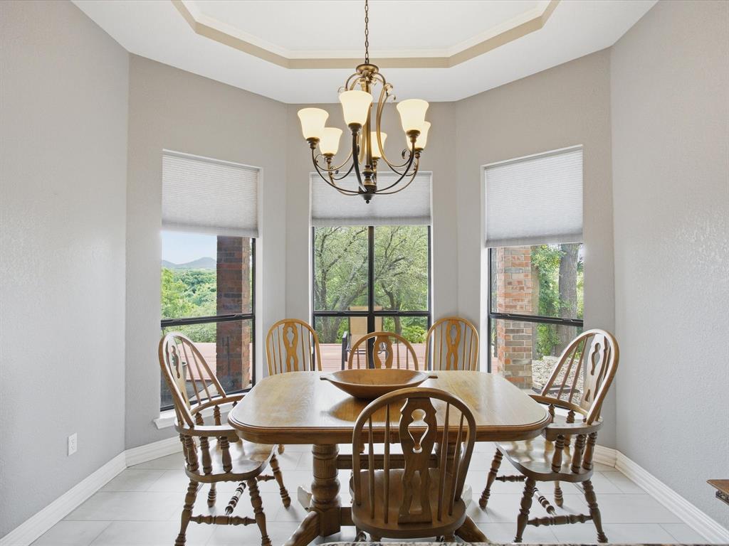 10106 Ravenswood Road Granbury, TX 76049 - Photo 3 of 39 a view of a dining room with furniture window and outside view