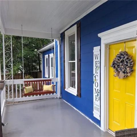 a front view of house with a garden
