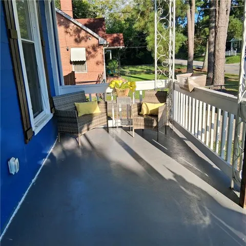 a view of a balcony with chairs