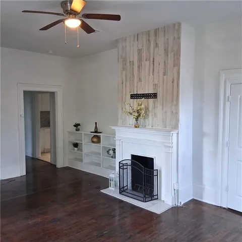a view of a livingroom with a fireplace and wooden floor