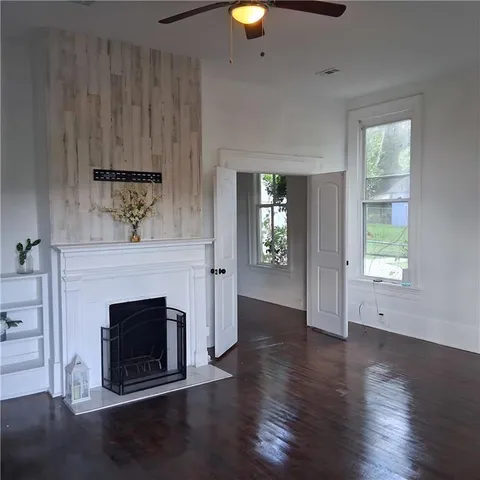 a view of a livingroom with a fireplace and window