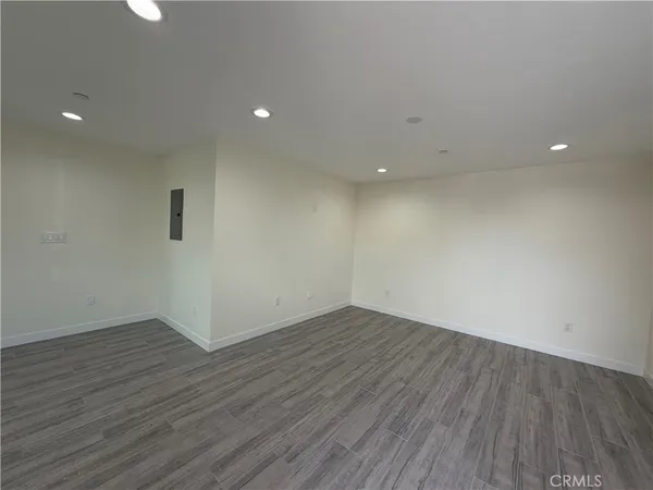 a kitchen with stainless steel appliances a refrigerator and wooden floor