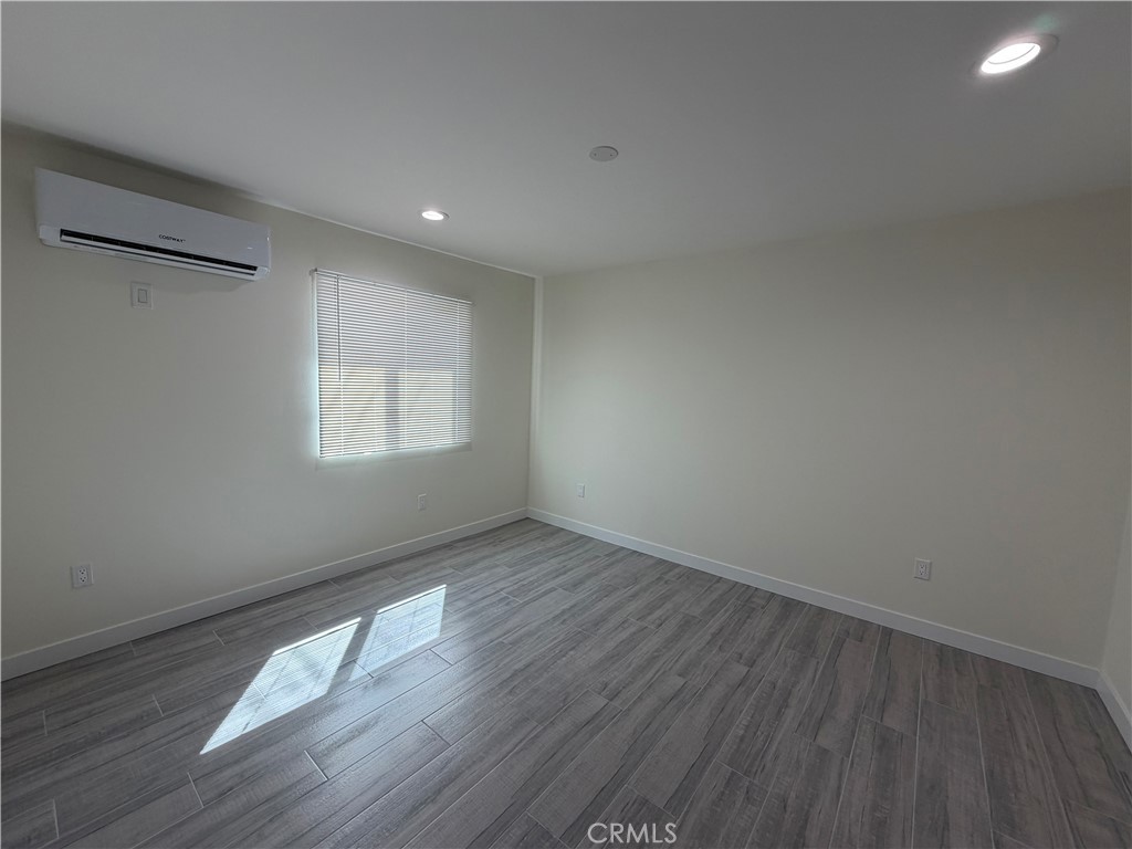 321 Elm Street Alhambra, CA 91801 - Photo 6 of 11 an empty room with wooden floor and windows
