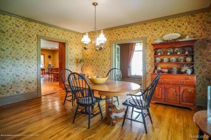 5301 Sherwood Road Webberville, MI 48892 - Photo 16 of 30 Formal dining room with original wood floors and crown molding!