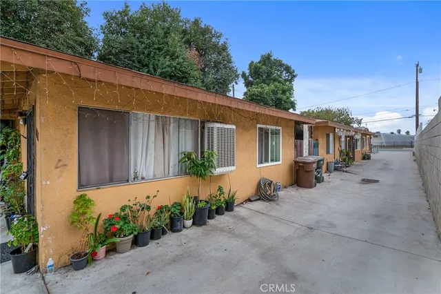 a backyard of a house with flower plants