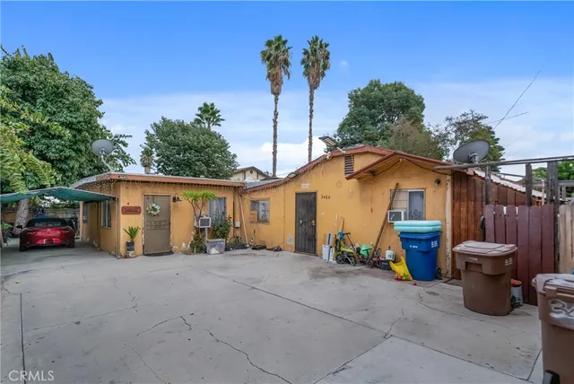 a view of a house with sitting area and potted plants