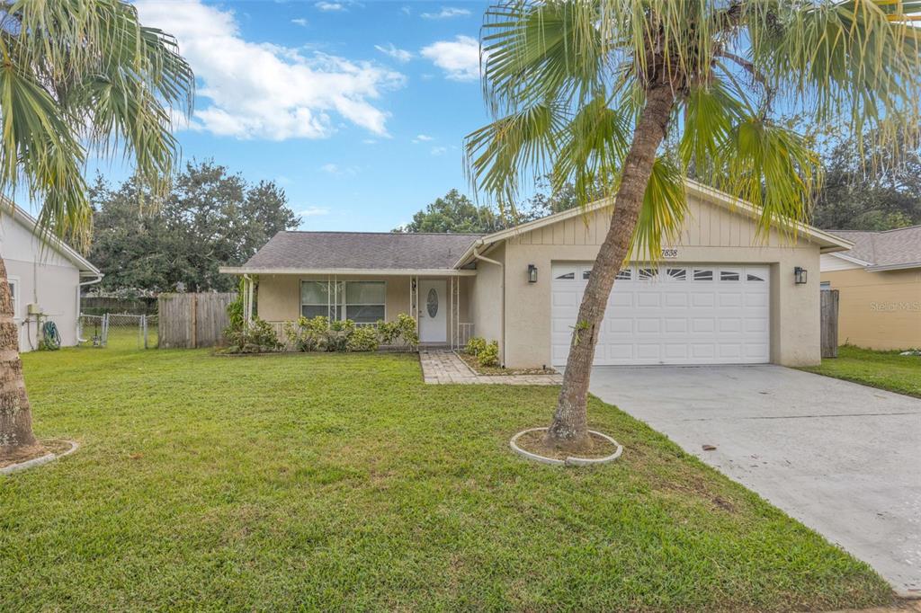 7838 Avenal Loop New Port Richey, FL 34655 - Photo 1 of 1 a front view of a house with garden