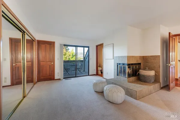 a bedroom with furniture and balcony