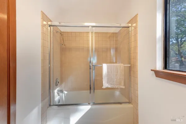 a bathroom with a glass shower door