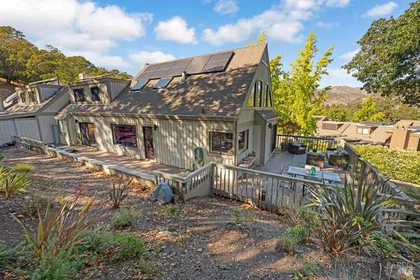a view of a house with wooden fence