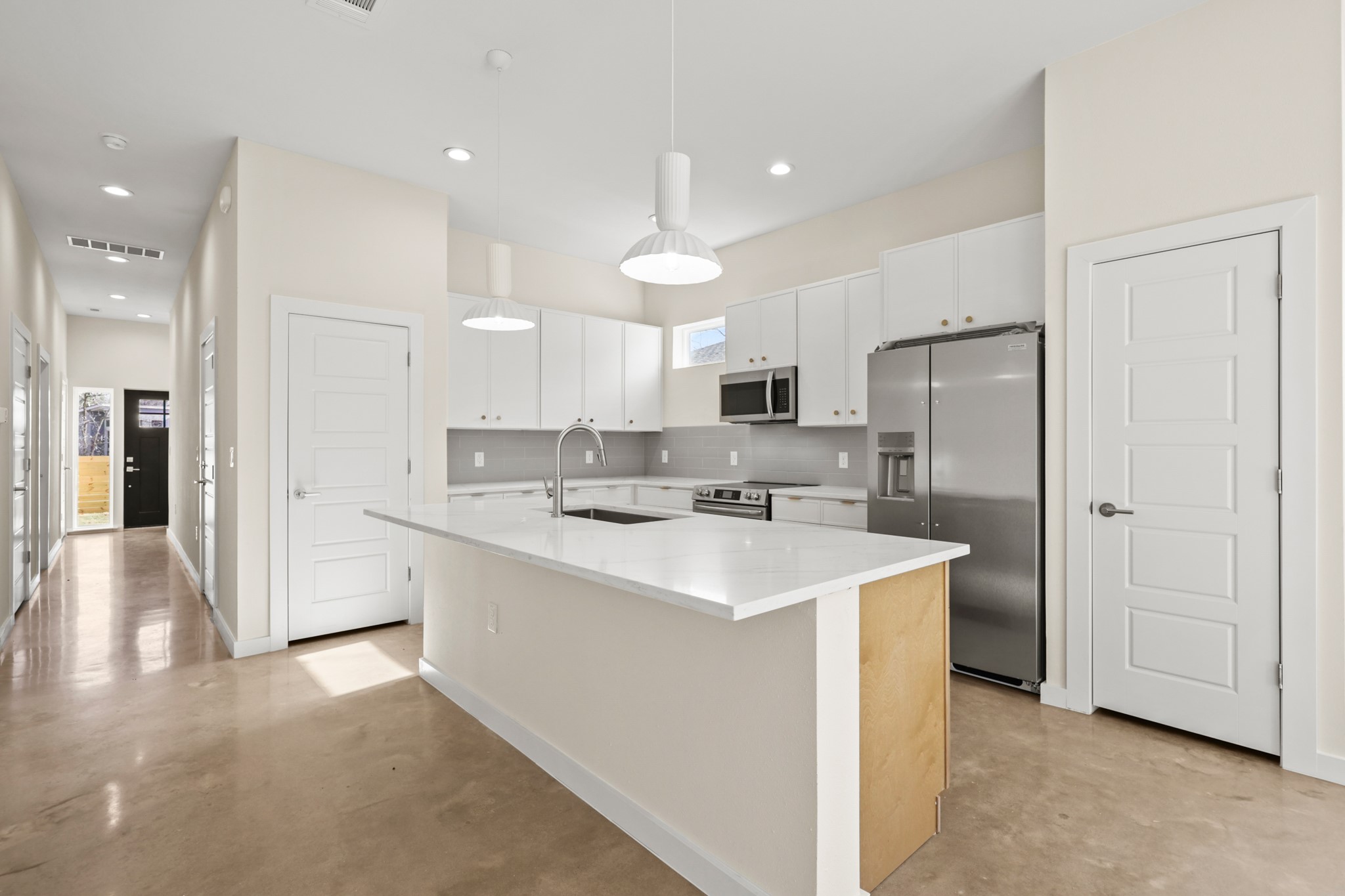 4801 Sara Drive, Unit B Austin, TX 78721 - Photo 23 of 40 a kitchen with white cabinets and stainless steel appliances