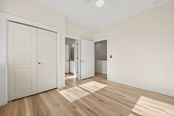 a view of a room with wooden floor and entryway