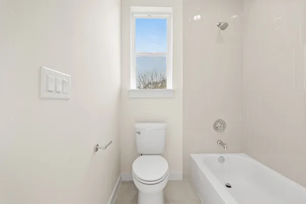 a bathroom with a toilet and a tub