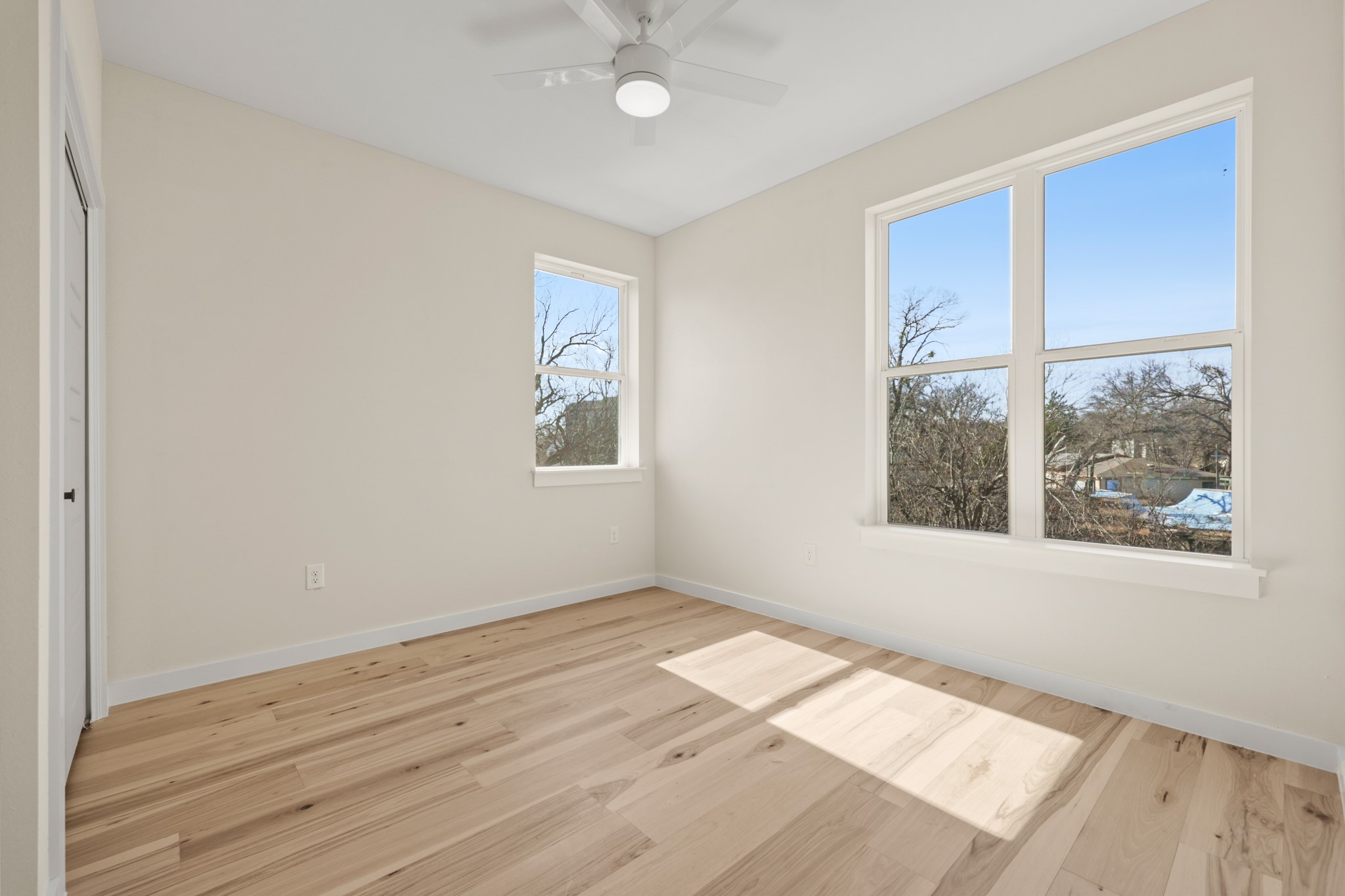4801 Sara Drive, Unit B Austin, TX 78721 - Photo 35 of 40 an empty room with wooden floor and windows