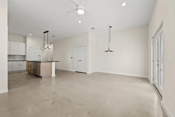 wooden floor in an empty room with a kitchen