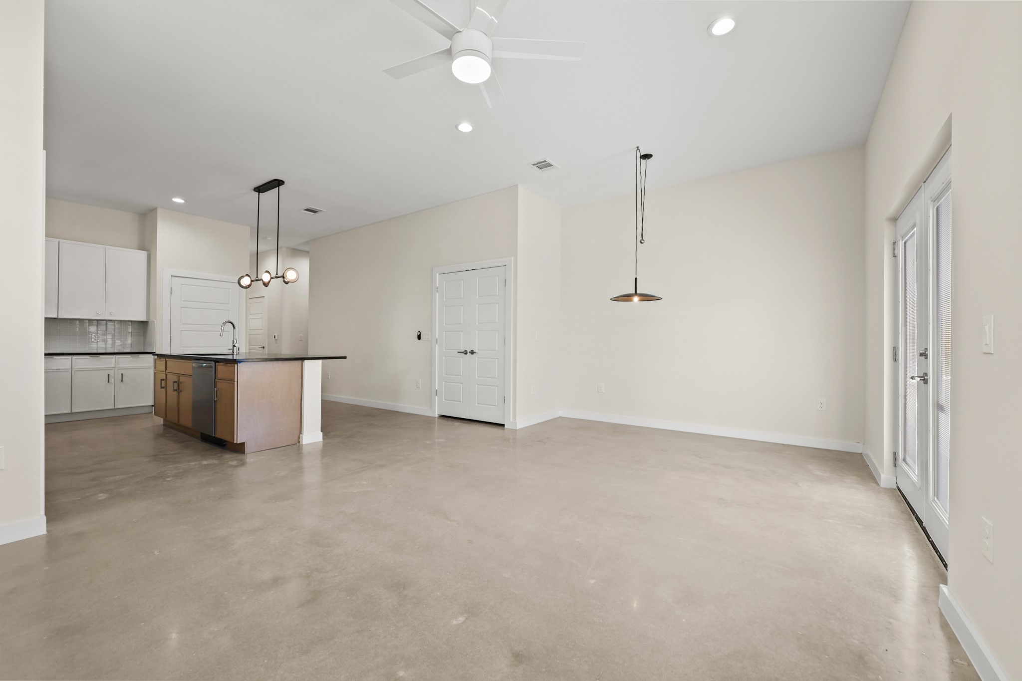 4801 Sara Drive, Unit B Austin, TX 78721 - Photo 7 of 40 wooden floor in an empty room with a kitchen