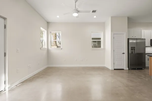 an empty room with windows and closet