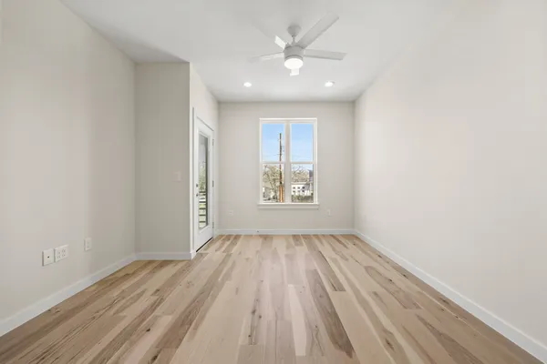 an empty room with closet and windows