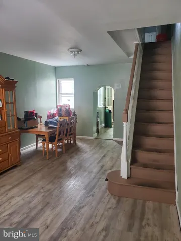 a view of a livingroom with furniture and staircase