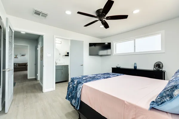 a spacious bedroom with a bed and a window