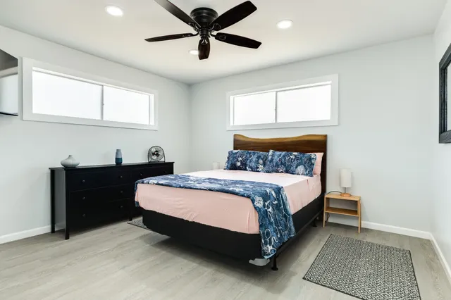 a kitchen with a sink a refrigerator a microwave and cabinets