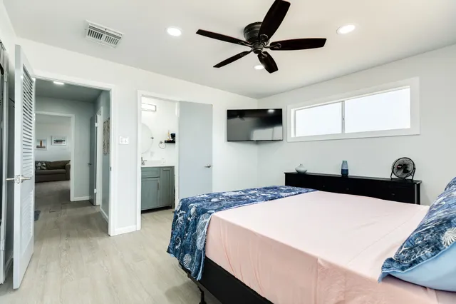 a spacious bedroom with a bed and a window