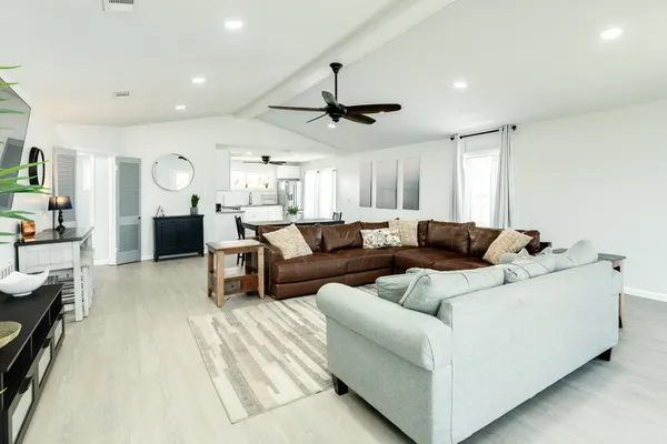 a living room with furniture and a chandelier