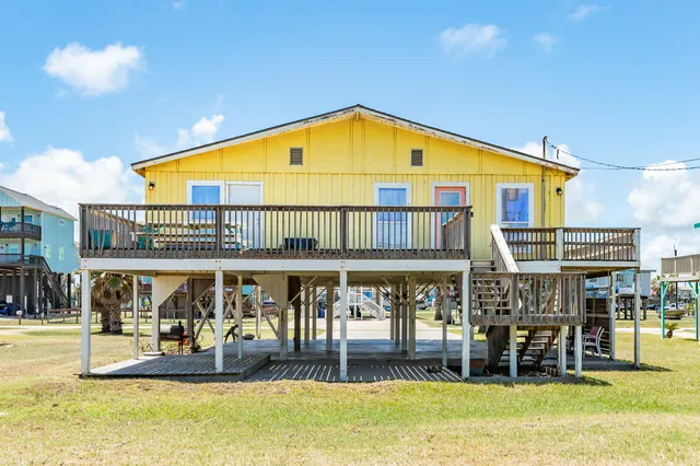 a view of a house with wooden deck