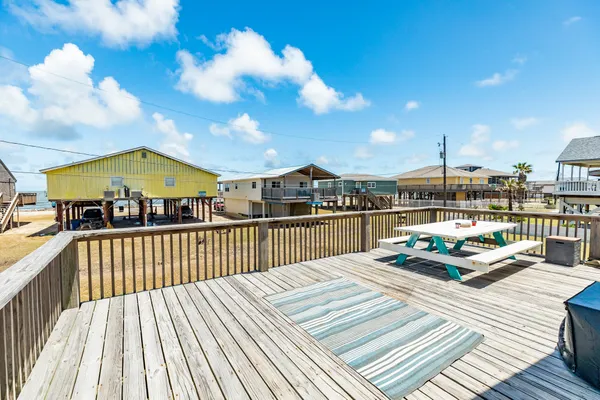 a view of balcony with wooden floor and outdoor seating