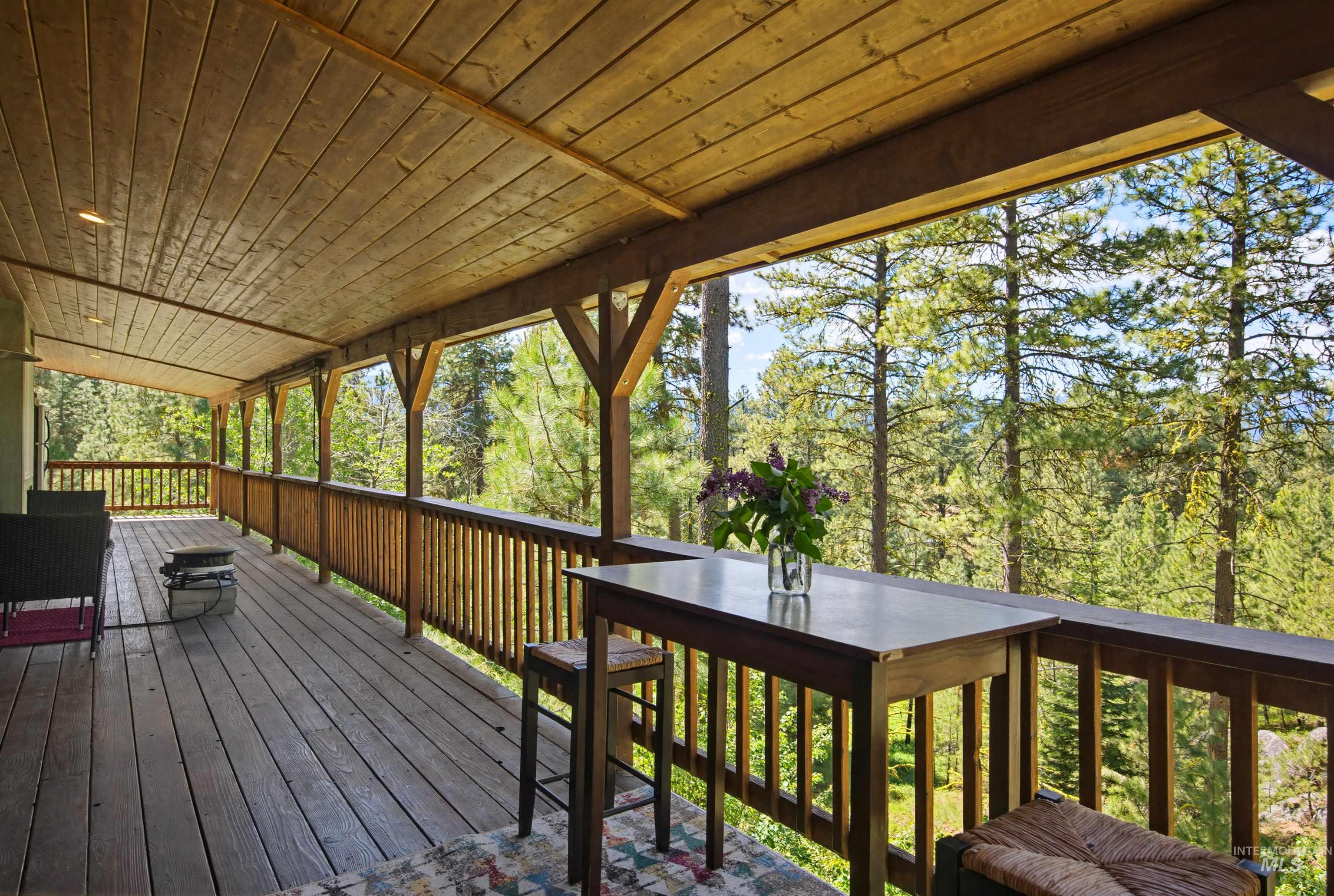 79 Sunset Loop Cascade, ID 83611 - Photo 17 of 44 Expansive wooden deck featuring a full-length wooden railing and a natural wood plank ceiling