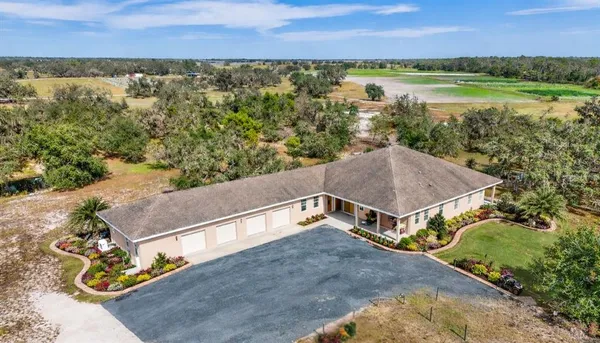 an aerial view of a house with outdoor space and lake view