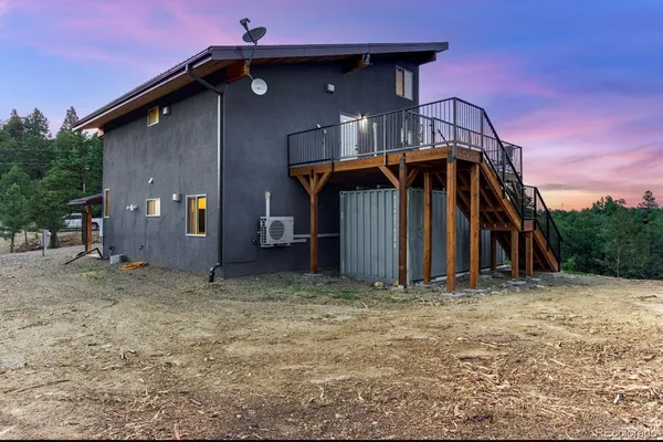 a view of a wooden house with a yard