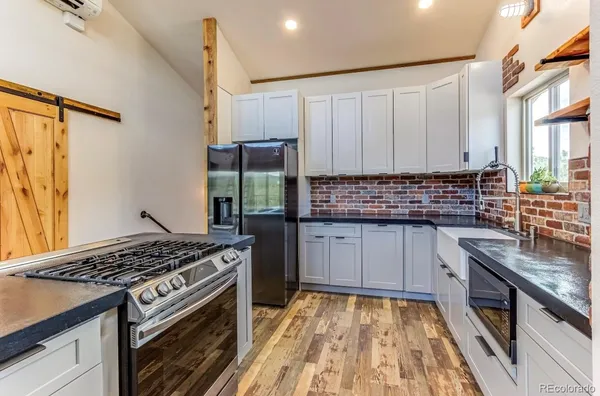 a kitchen with sink a stove and cabinets
