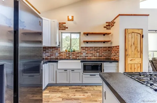 a kitchen with stainless steel appliances granite countertop a stove and a refrigerator