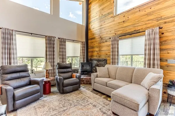 a living room with furniture and large windows