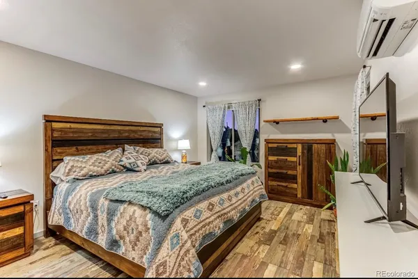 a bedroom with a bed and a flat tv screen