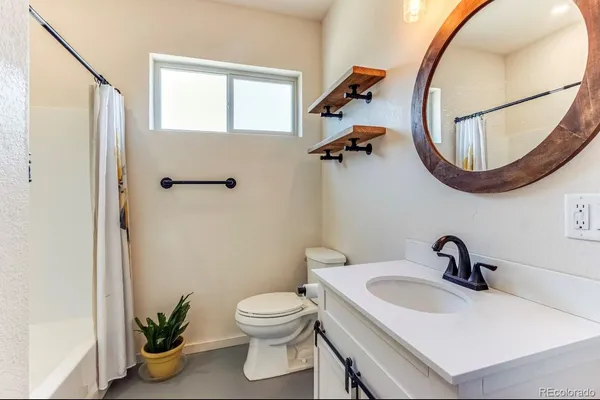 a bathroom with a sink a mirror and a toilet
