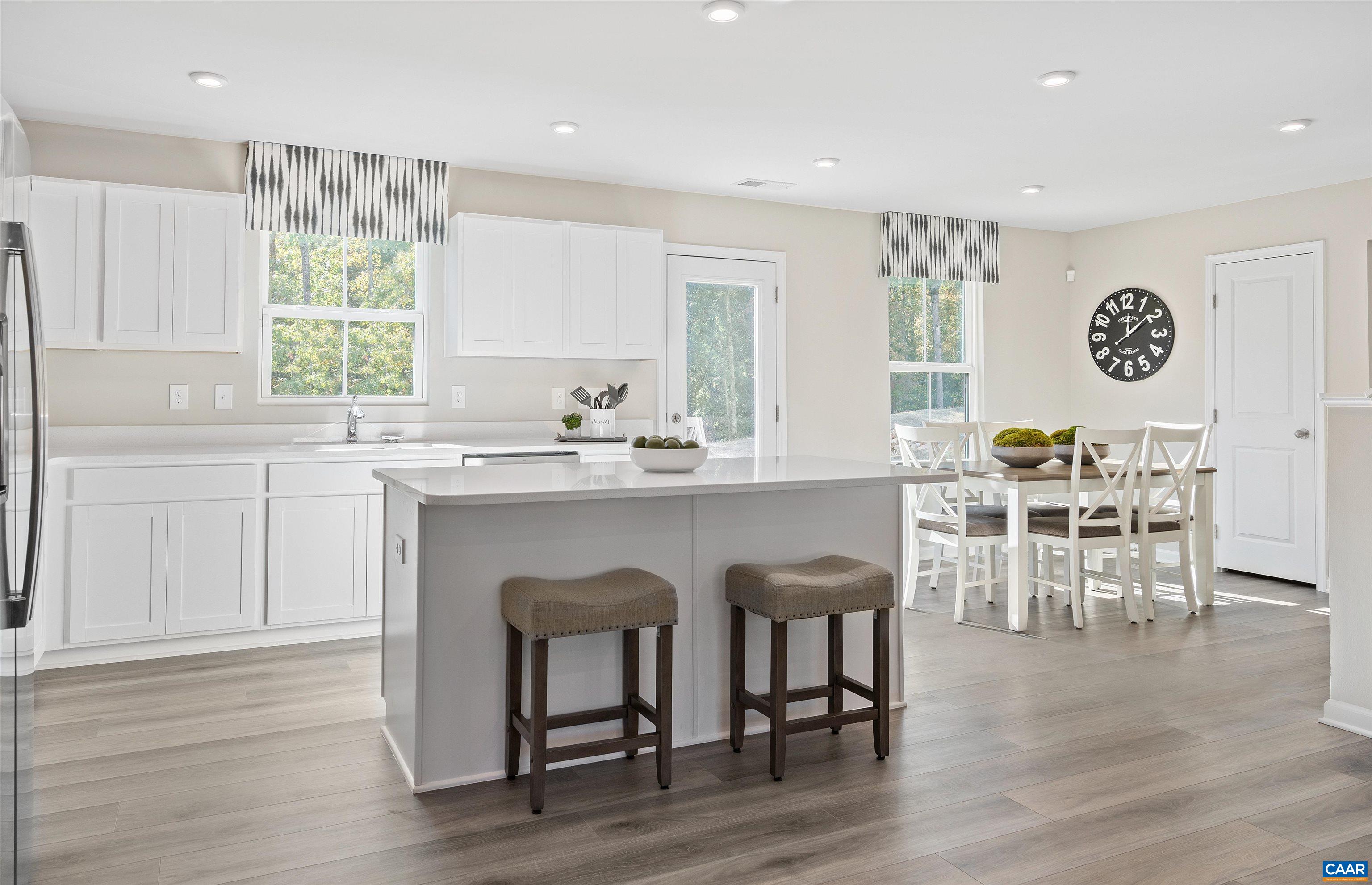 63 Everglades Road Barboursville, VA 22923 - Photo 4 of 13 a kitchen with stainless steel appliances granite countertop a table chairs and a refrigerator